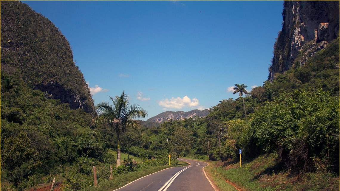 Flat, winding road between 'mogotes' near Vinales Valley in Pinar del Rio, Cuba