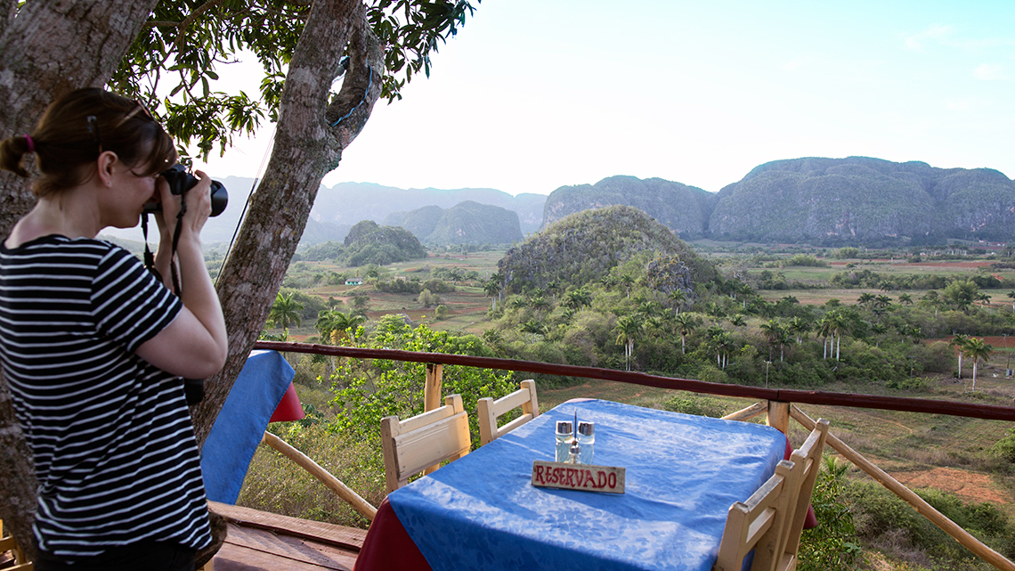 Traveller takes pictures of Vinales Valley from one of the local paladares