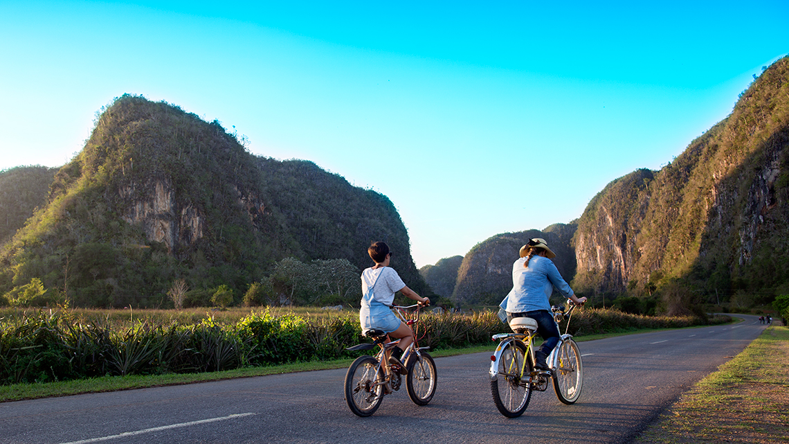 Tourist discovering the Vinales Valley in bike