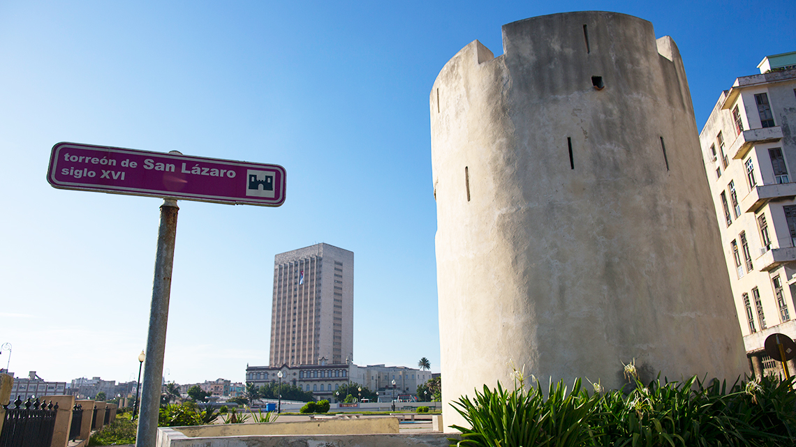 Torreon de San Lazaro and its sign, in the background Hermanos Ameijeiras Hospital