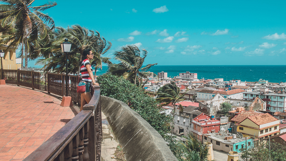 Tourist admiring the beatiful views of the sea and the city of Baracoa