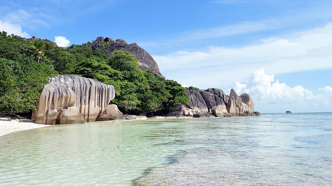 Massive rounded boulders on a white sand beach, one of the symbols of the Seychelles