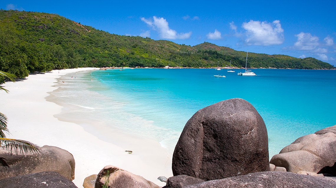 Boats arriving to the shores of Anze Lazio in Praslin Island, Seychelles