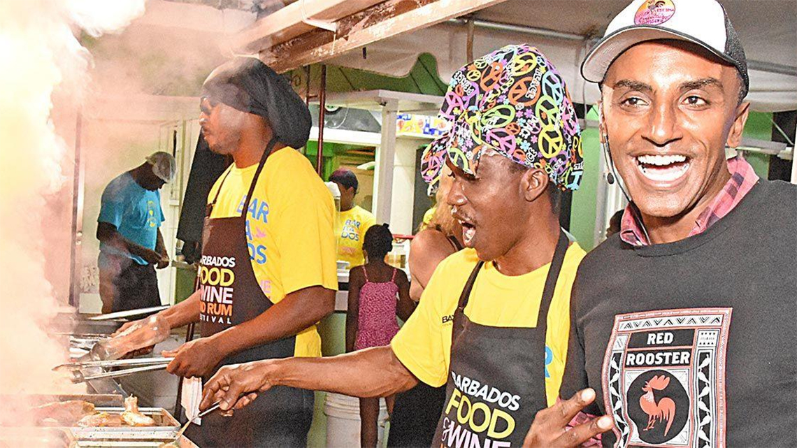 Chef in a street stall trading jokes with passing tourist in Barbados